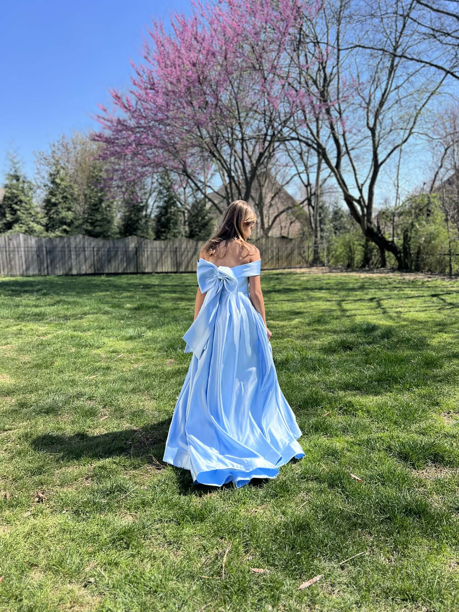 A little girl modeling a blue princess dress.