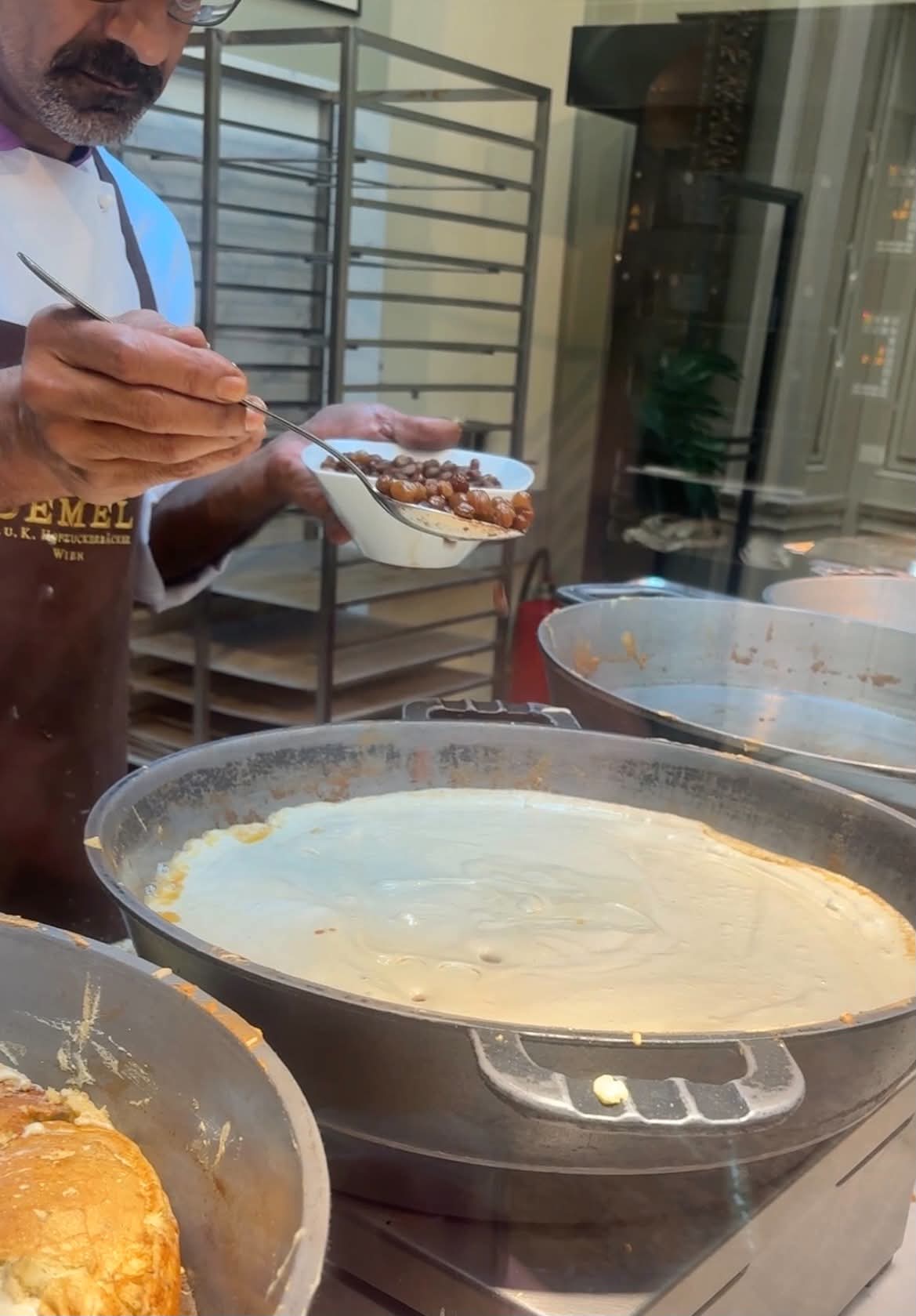 Man putting nuts into delicious dessert.