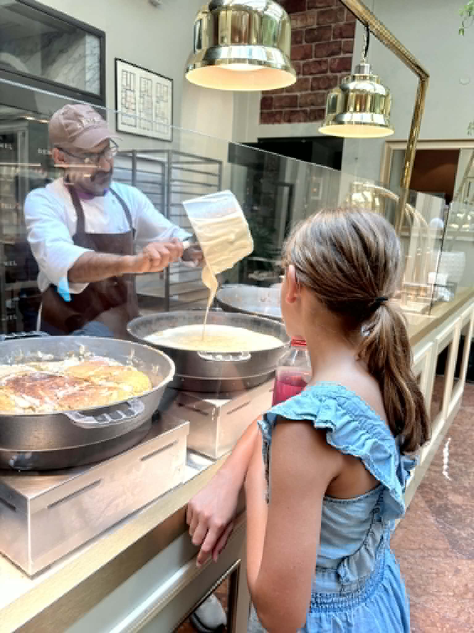 Girl watching the desserts being made.