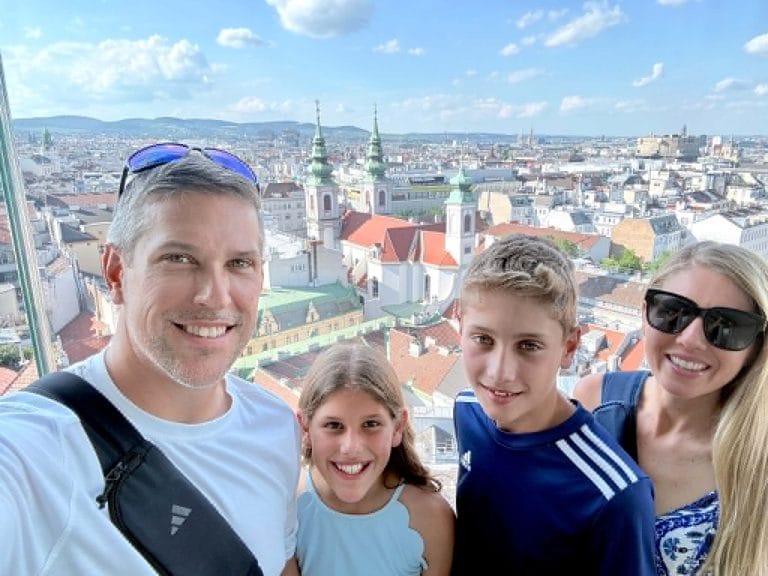 A family in Vienna with kids / teenagers on a rooftop overlooking the city.