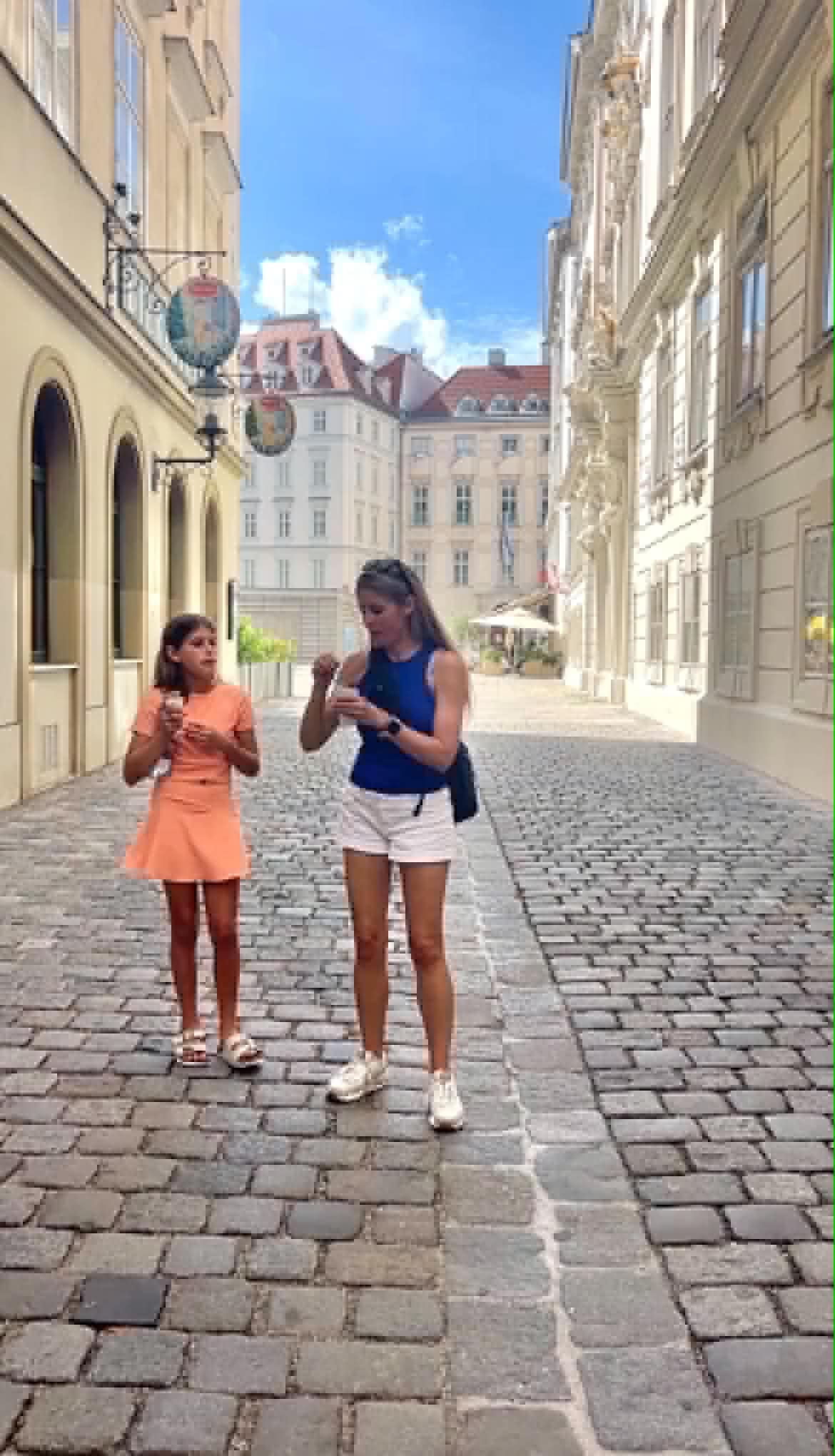 Girl an women talking in Vienna while eating ice cream.