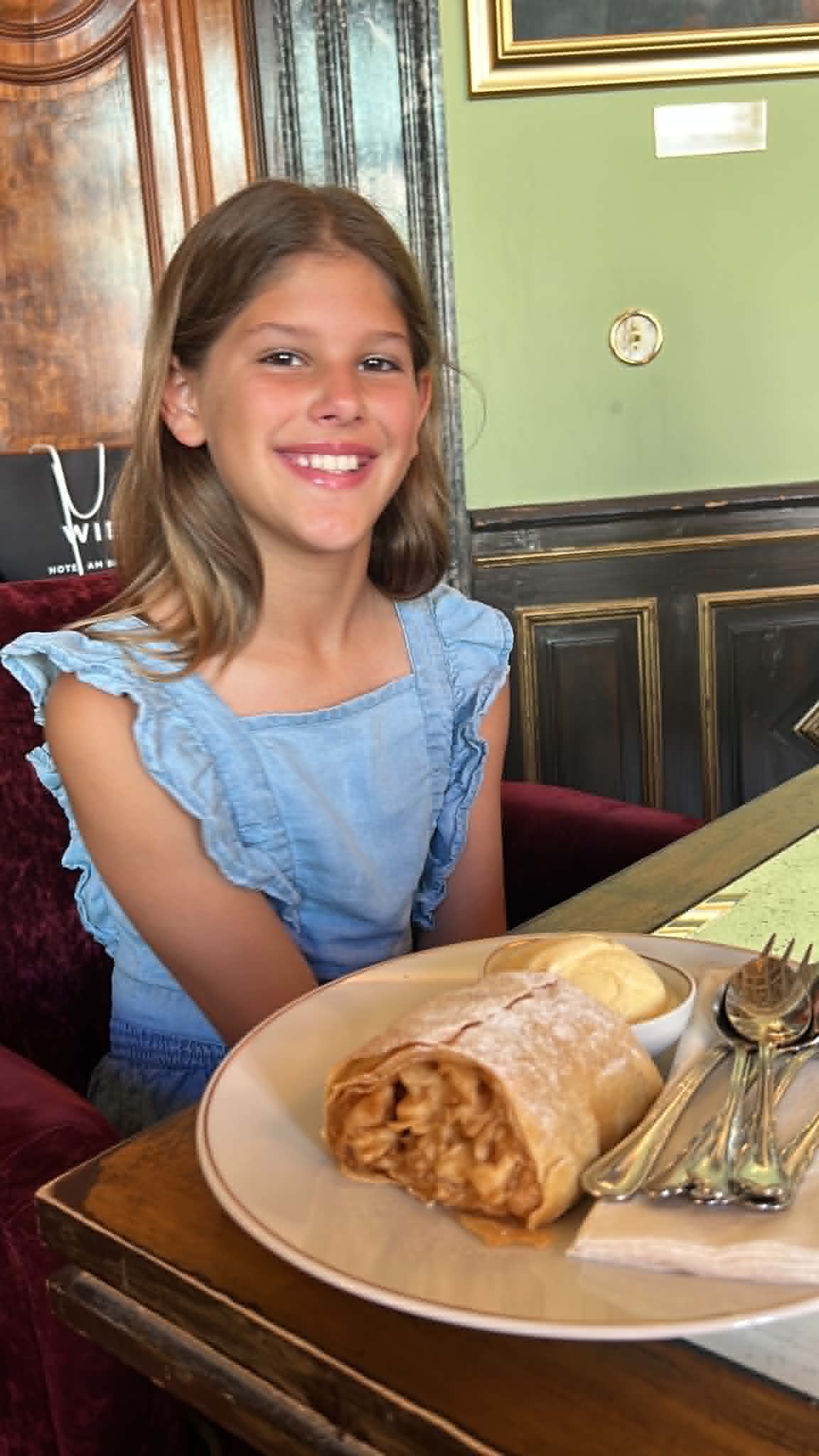 Girl with delicious apple strudel and ice cream.
