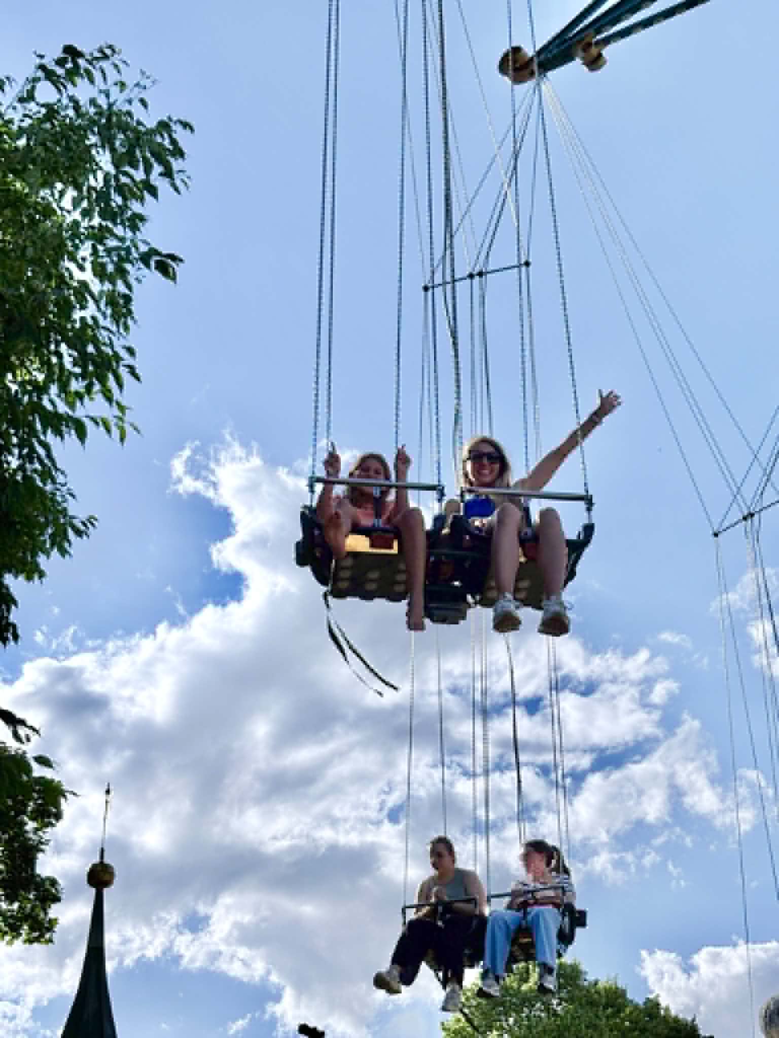 Girl and Women riding on swings.