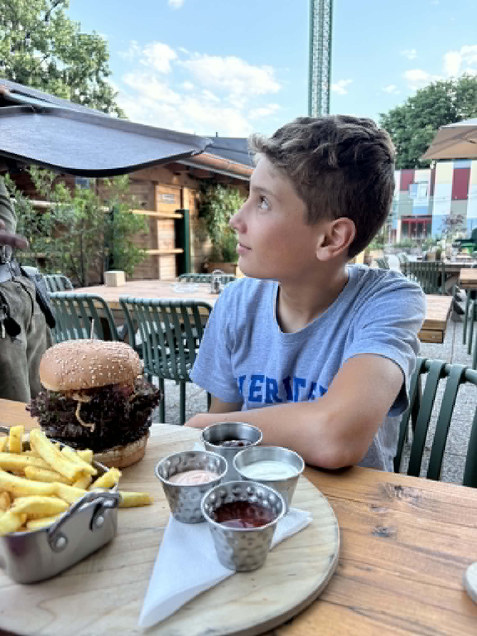 Boy with a Prater Burger and french fries.