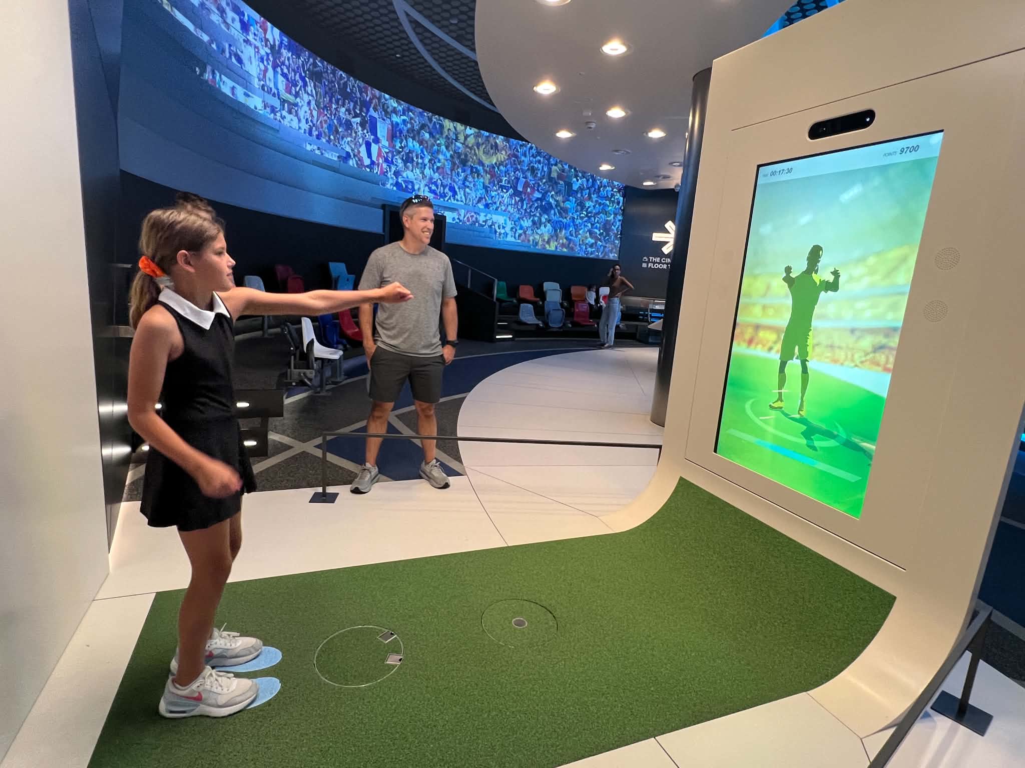 A little girl learning a celebration goal dance at the FIFA Museum in Zurich, Switzerland.