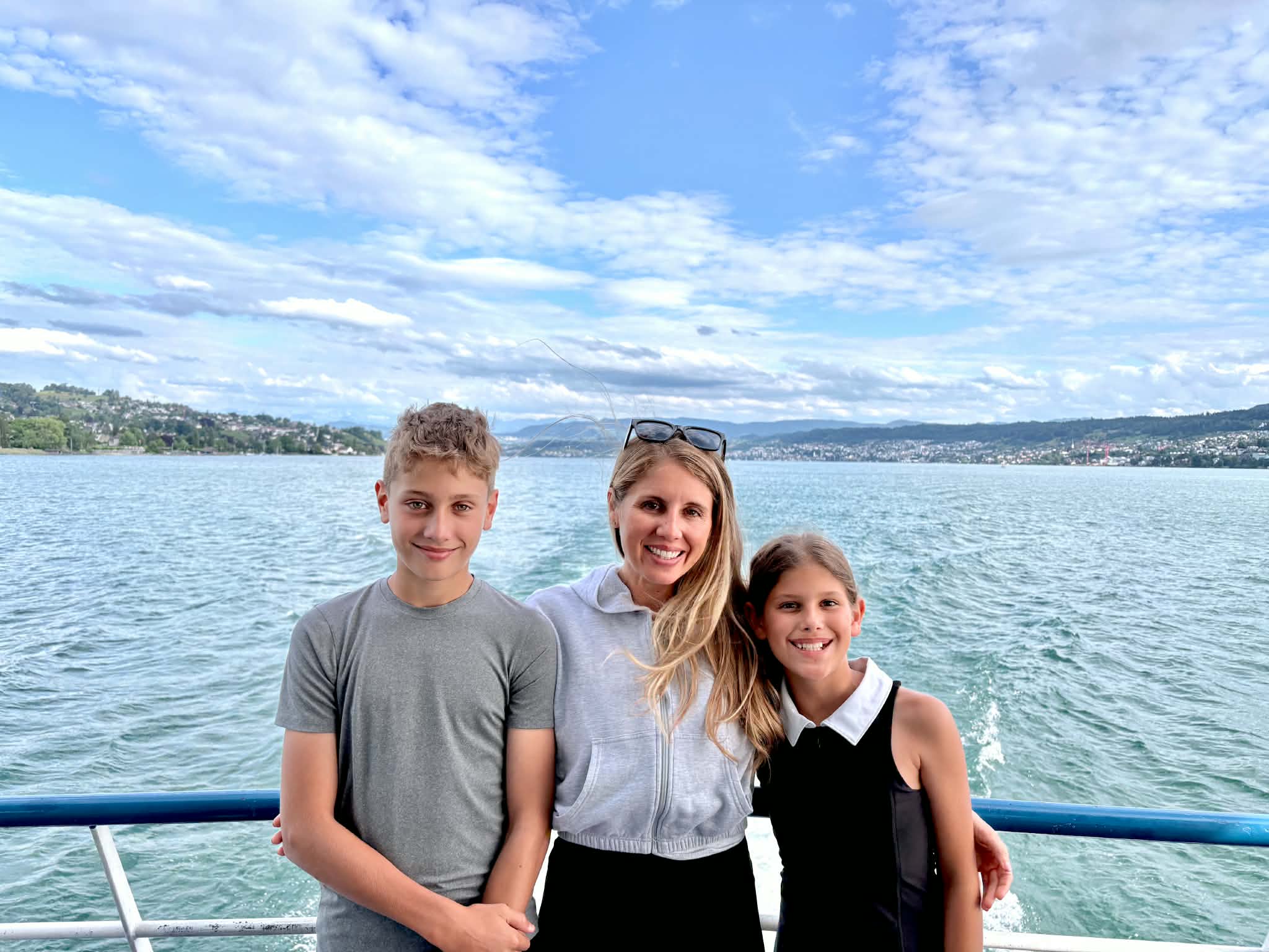 A mom enjoying a boat ride in Zurich with her kids.