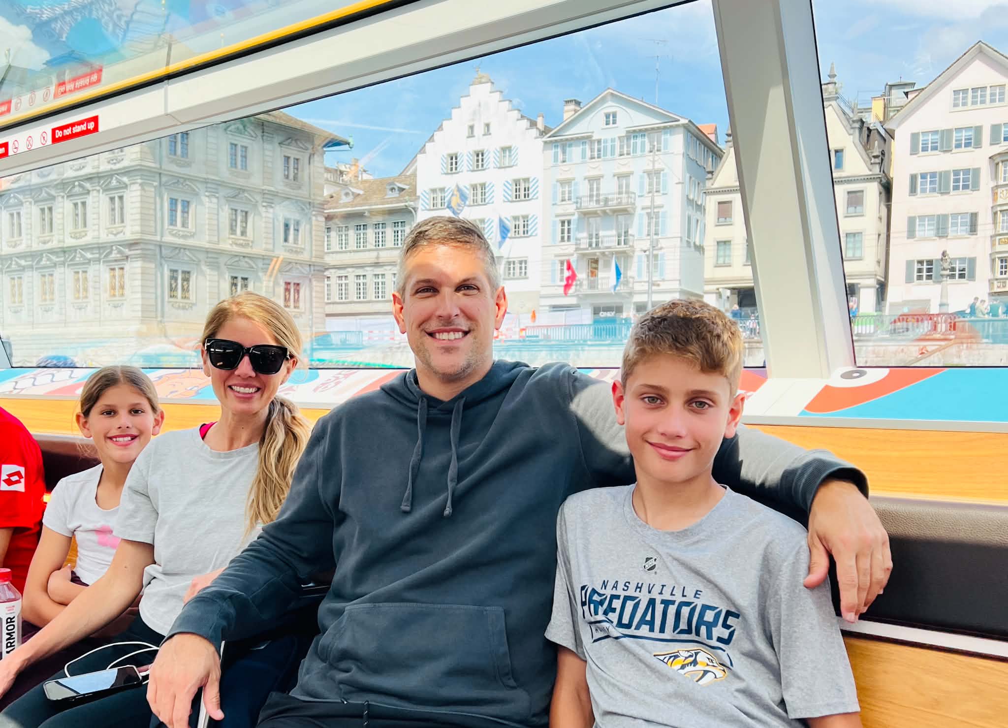 A family on a boat in Zurich with their kids.