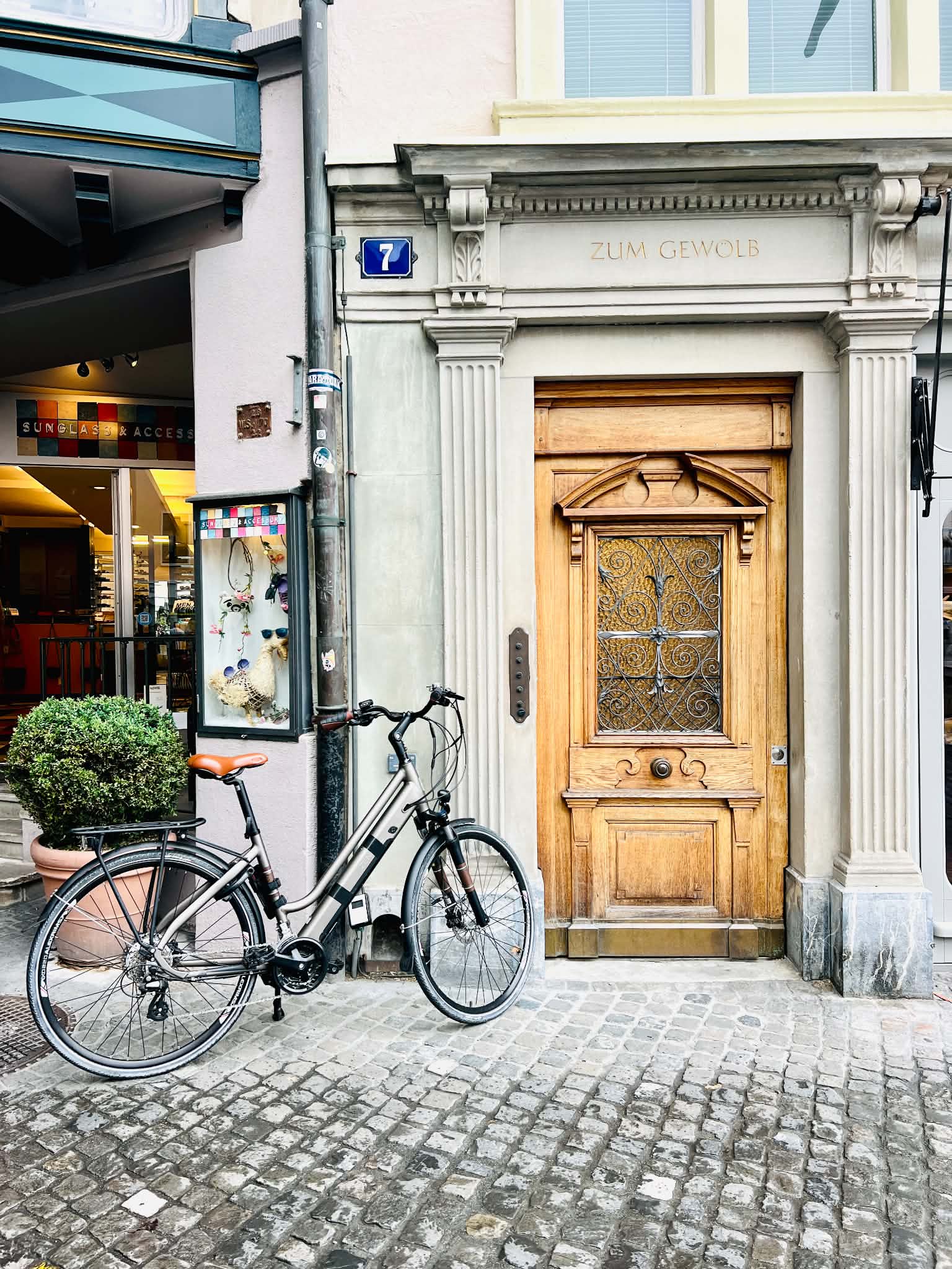 A really pretty wooden door with a bicycle next to it in Zurich, Switzerland.