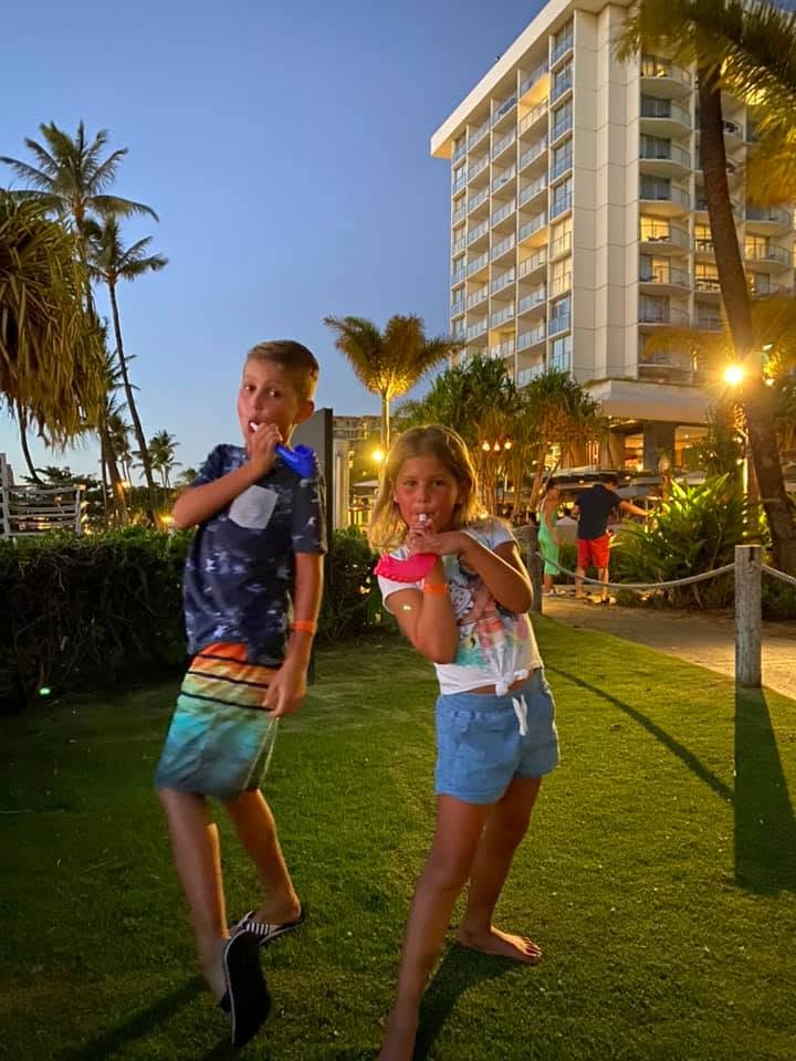 Two kids blowing their trumpets on Rosh Hashanah.