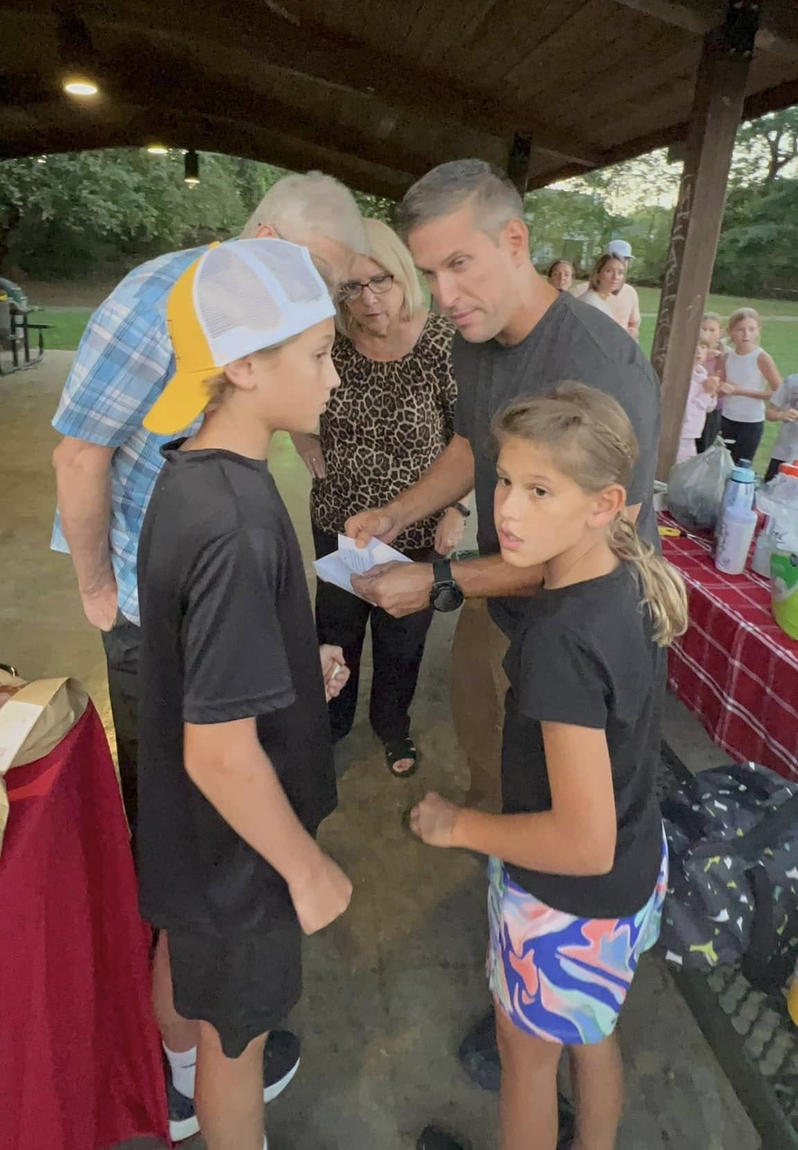 A family reading their clue cards for the Feast of Trumpets scavenger hunt.