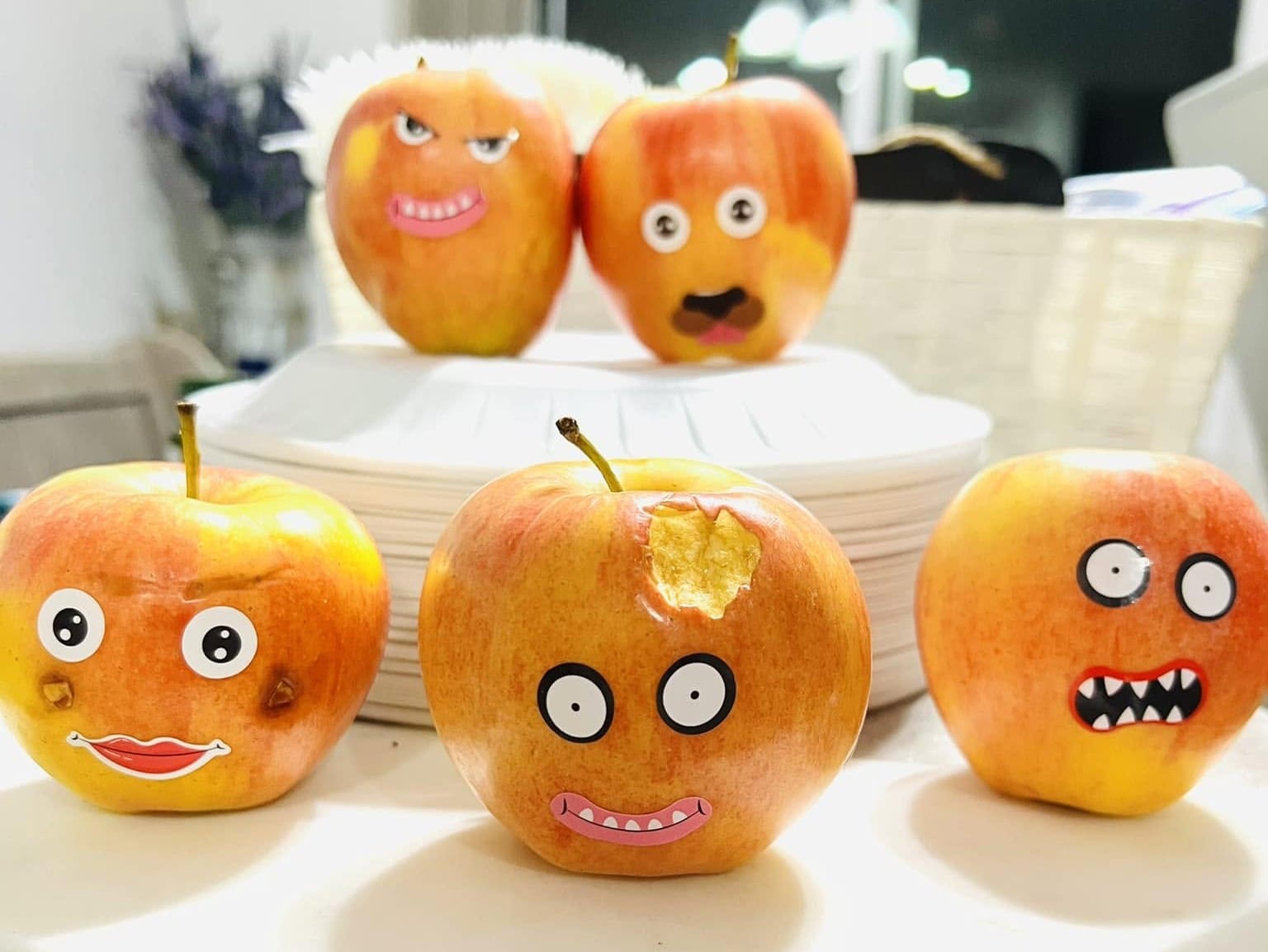5 apples covered in funny face stickers for the Feast of Trumpets celebration.