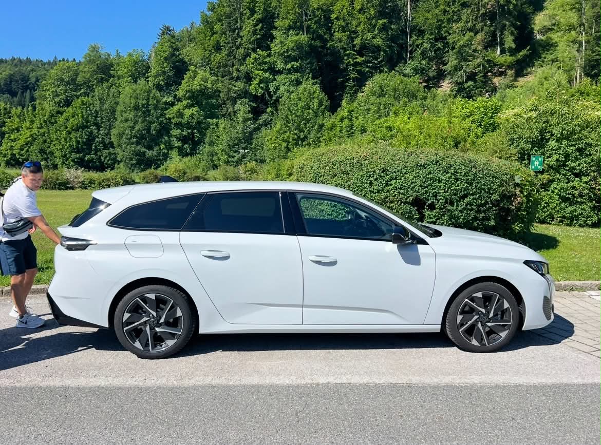 A man loading up the rental car on his European vacation.
